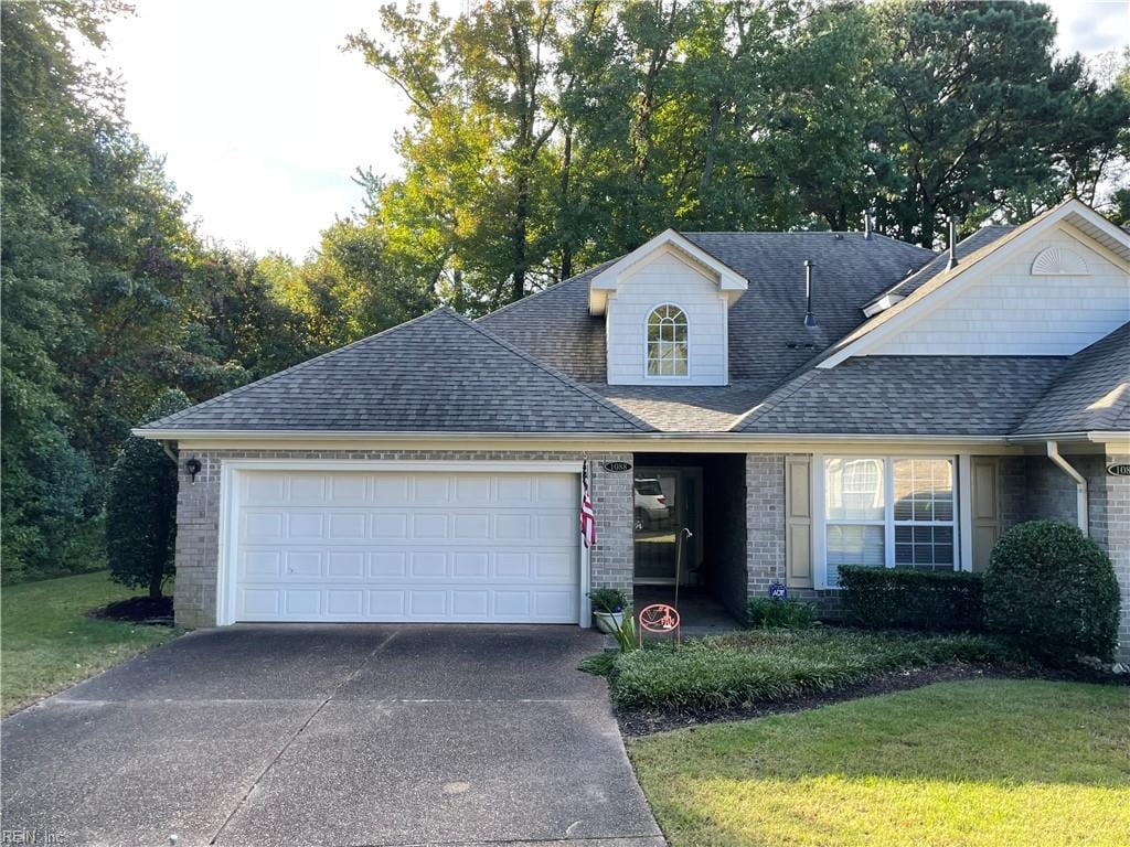 view of front of property featuring a garage and a front lawn