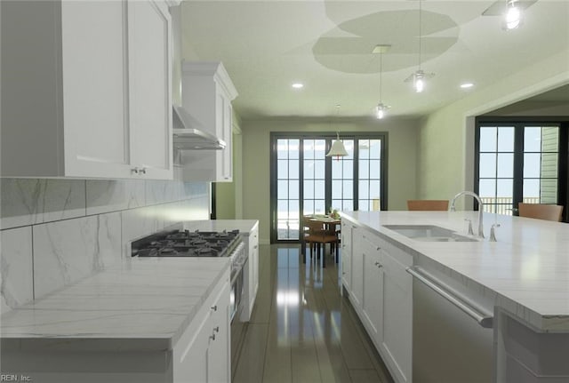 kitchen featuring a spacious island, sink, appliances with stainless steel finishes, and white cabinetry