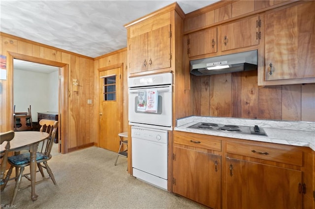 kitchen featuring wood walls and white appliances