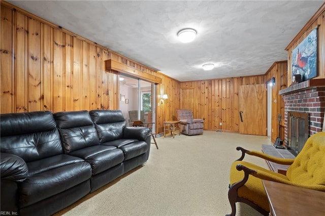 living room with wood walls, a brick fireplace, and light colored carpet