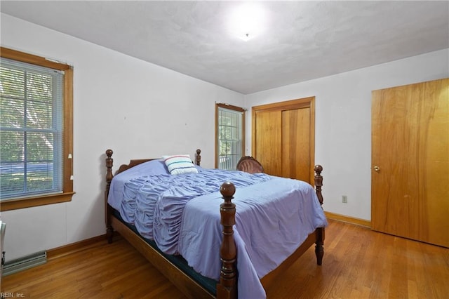 bedroom featuring hardwood / wood-style flooring and multiple windows