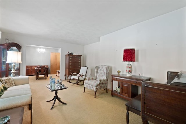 living room with light carpet and an inviting chandelier