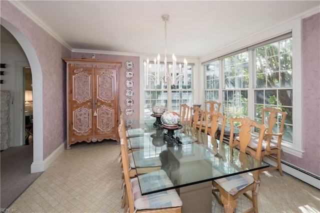 dining area featuring crown molding, an inviting chandelier, and baseboard heating