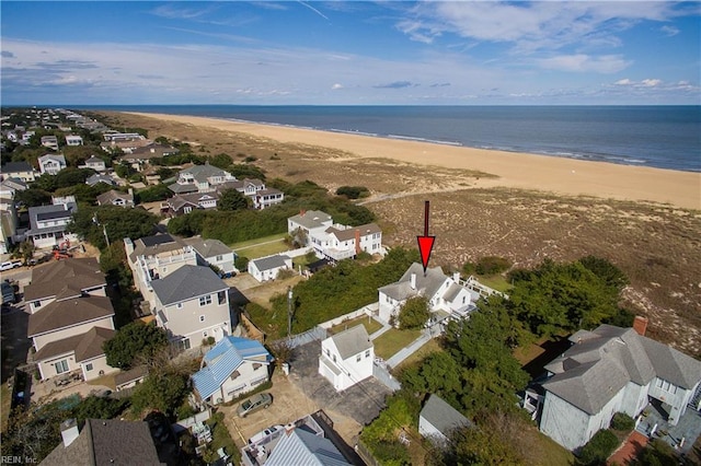 birds eye view of property with a water view and a view of the beach