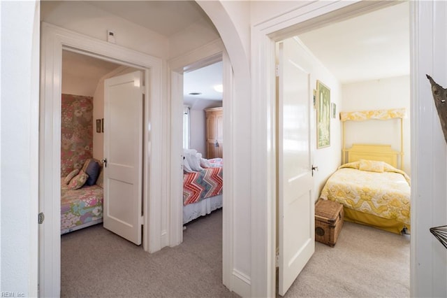 hallway featuring light colored carpet