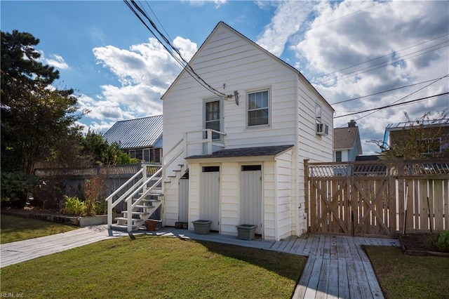 rear view of house with a yard