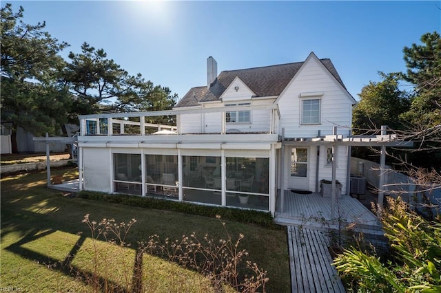 6904 Ocean Front Ave, Virginia Beach, VA 23451 - rear view of house with a chimney, a sunroom, a deck, and a lawn