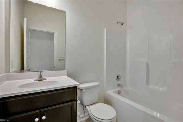 bathroom featuring toilet, vanity, and shower / tub combination