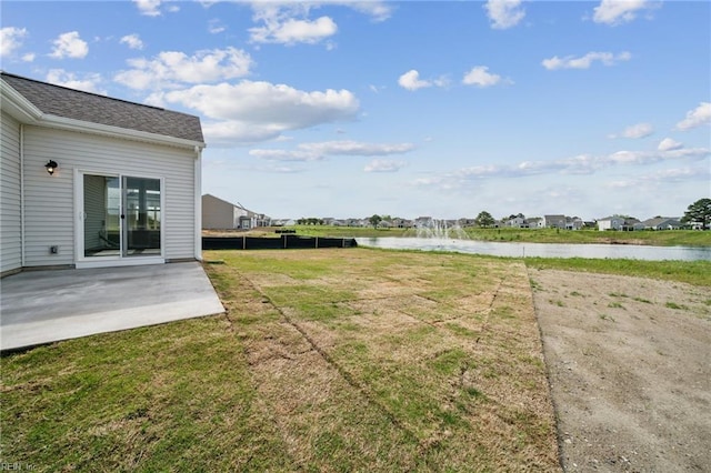 view of yard with a patio area and a water view