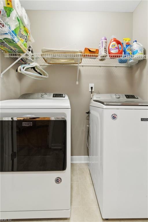 laundry room featuring light tile patterned flooring and washer and dryer