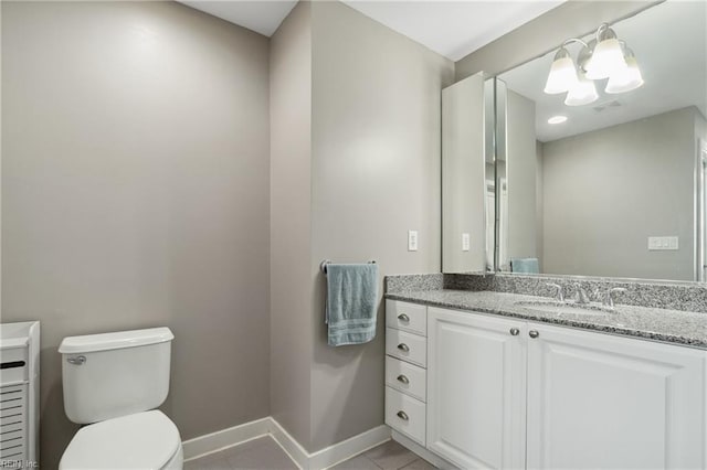 bathroom featuring tile patterned floors, vanity, and toilet