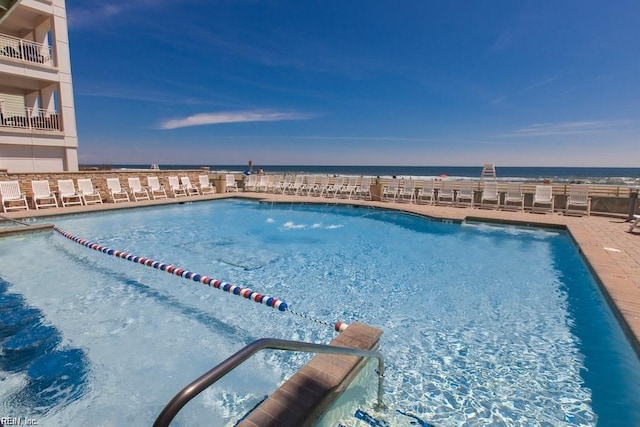 view of pool with a water view