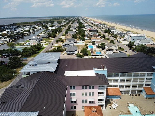 birds eye view of property featuring a beach view and a water view