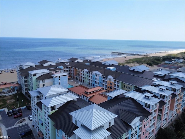 birds eye view of property featuring a water view and a view of the beach