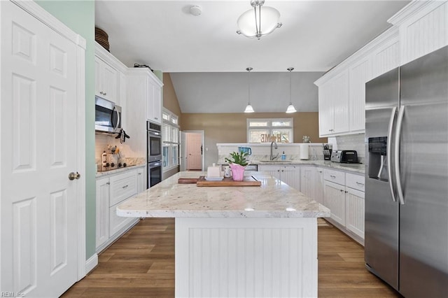 kitchen featuring hanging light fixtures, sink, dark wood-type flooring, white cabinetry, and appliances with stainless steel finishes