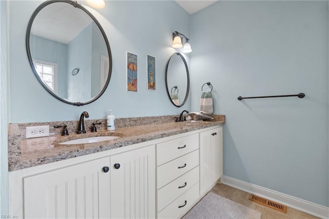 bathroom featuring tile patterned floors and vanity