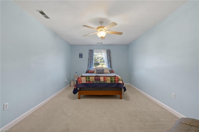 bedroom with ceiling fan and light carpet