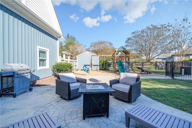 view of patio / terrace with a playground, a storage unit, a fire pit, and a grill