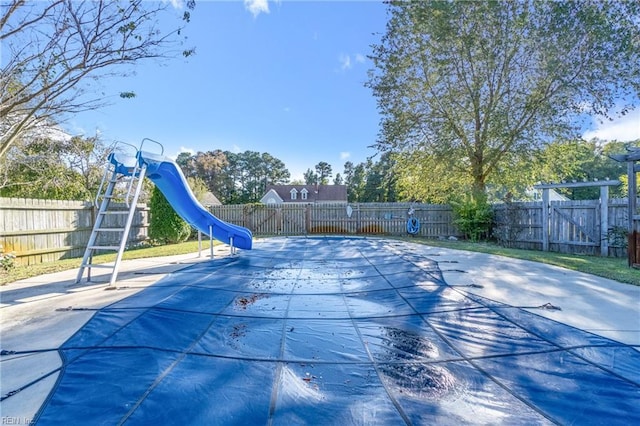 view of swimming pool with a water slide