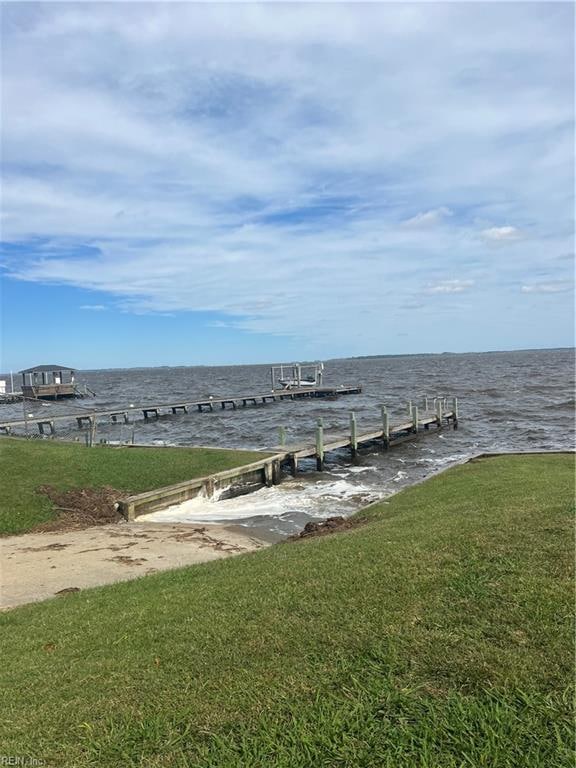 dock area featuring a water view and a yard