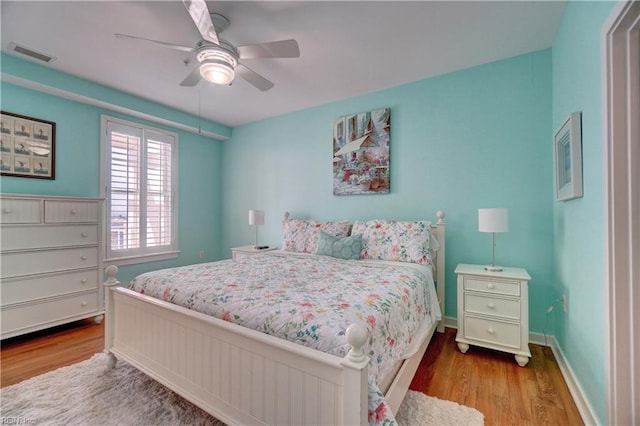 bedroom with hardwood / wood-style floors and ceiling fan