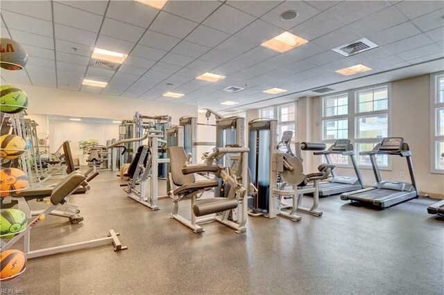 gym with a paneled ceiling