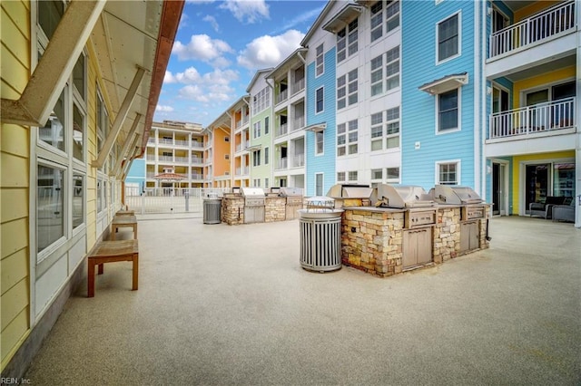 view of home's community featuring an outdoor kitchen and a patio area