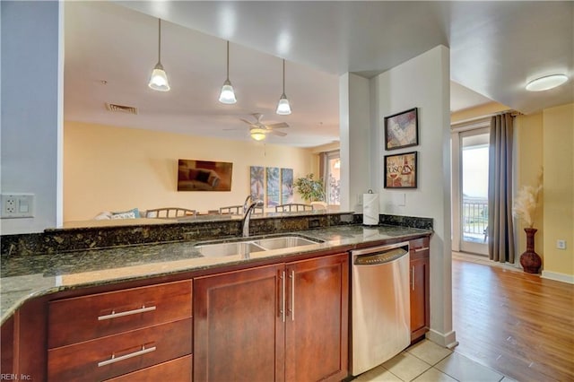 kitchen with dark stone counters, sink, stainless steel dishwasher, light hardwood / wood-style floors, and ceiling fan