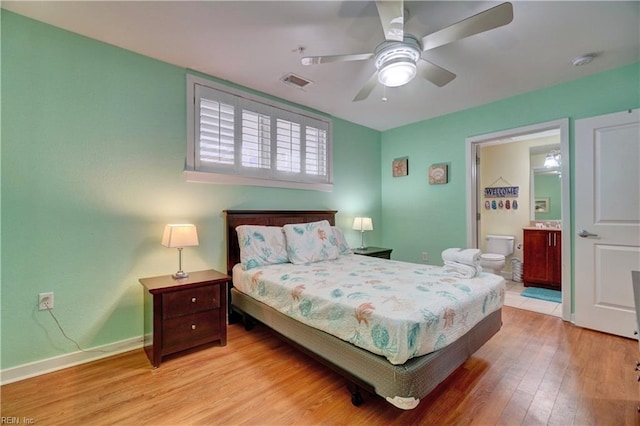 bedroom featuring light hardwood / wood-style floors, ensuite bath, and ceiling fan