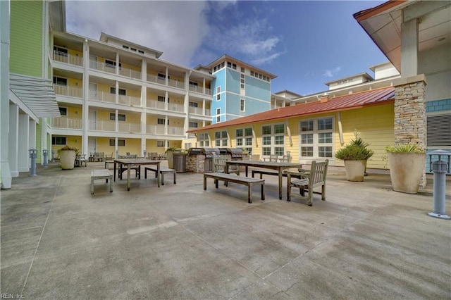 view of patio with a balcony and area for grilling