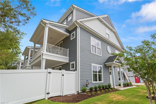 view of home's exterior with a lawn and a balcony