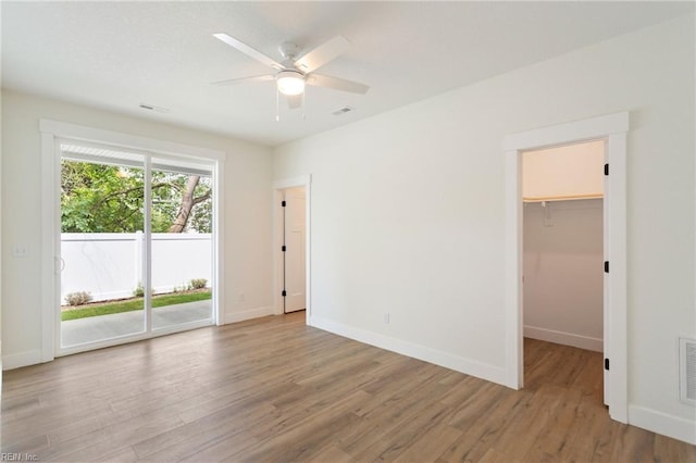 spare room with light hardwood / wood-style flooring and ceiling fan