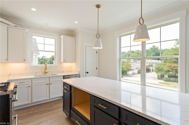 kitchen with a wealth of natural light, sink, and white cabinets