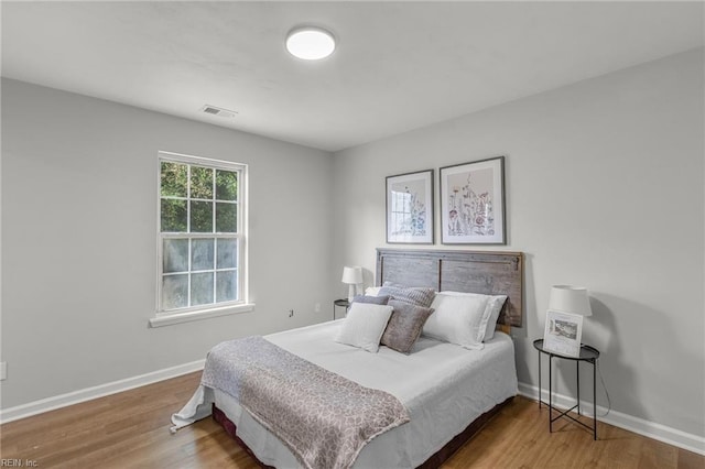 bedroom with hardwood / wood-style flooring