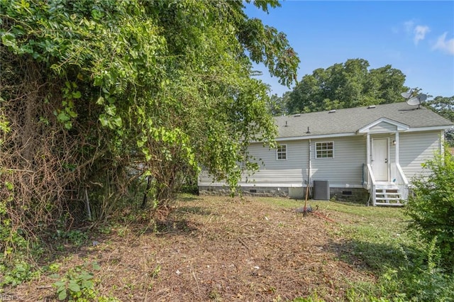 rear view of house with central AC unit