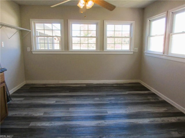 spare room with dark hardwood / wood-style flooring and ceiling fan