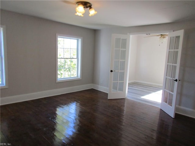 unfurnished room featuring ceiling fan, french doors, and dark hardwood / wood-style flooring