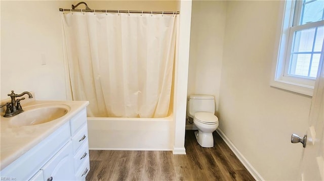 full bathroom with hardwood / wood-style flooring, toilet, vanity, and shower / bathtub combination with curtain