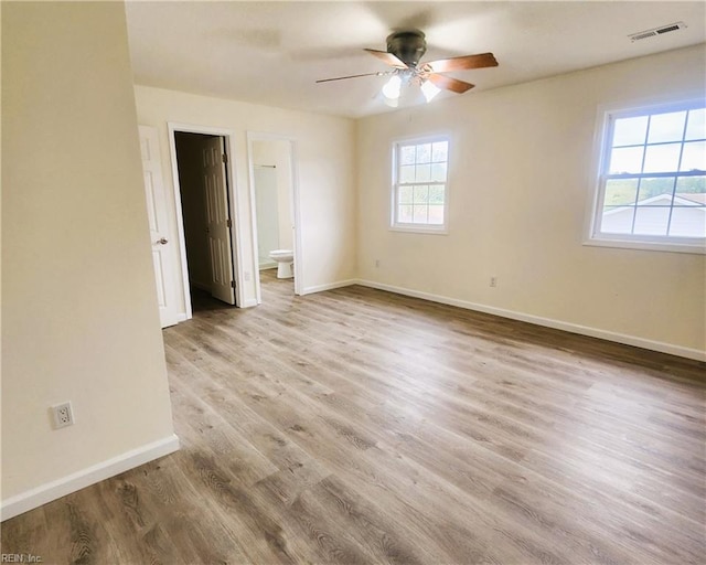 unfurnished room featuring light wood-type flooring and ceiling fan