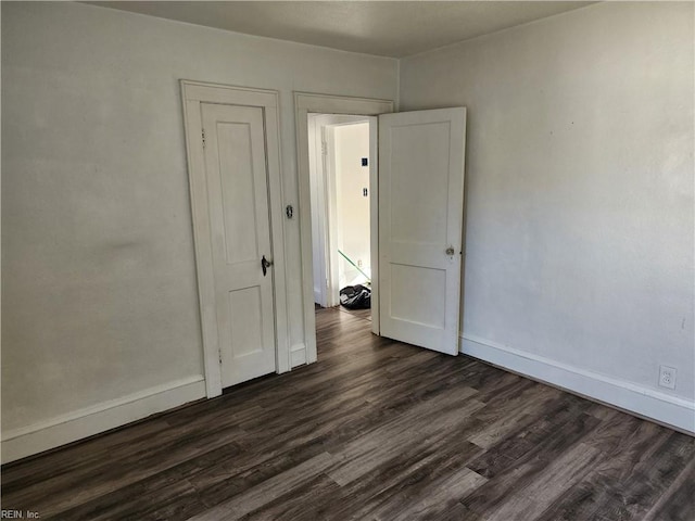 empty room featuring dark hardwood / wood-style flooring