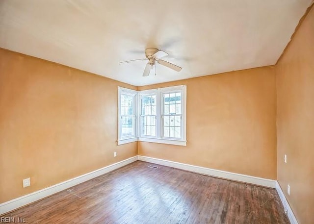 unfurnished room with ceiling fan and hardwood / wood-style floors