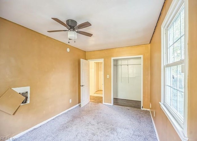 unfurnished bedroom featuring ceiling fan, carpet floors, and a closet