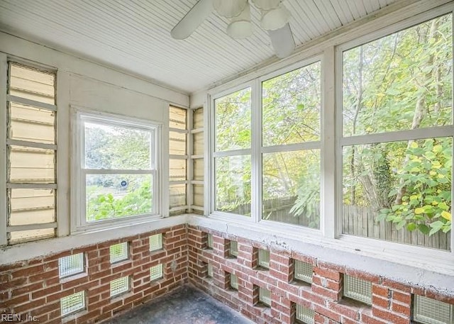 unfurnished sunroom with ceiling fan