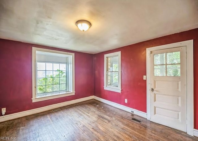 foyer entrance with hardwood / wood-style floors and a healthy amount of sunlight