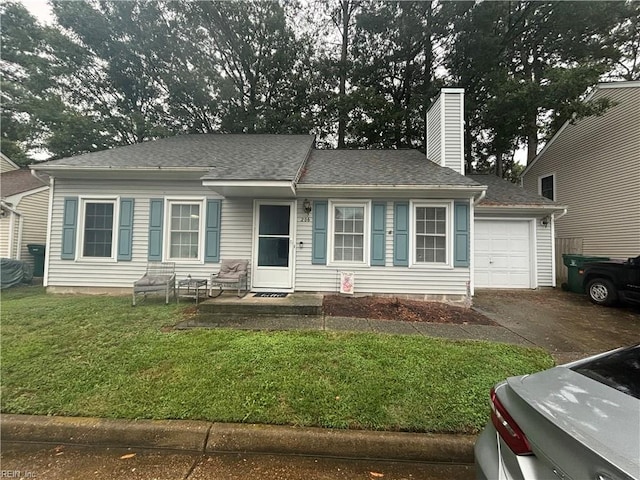 view of front of property with a garage and a front lawn