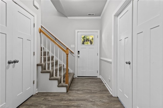 entrance foyer with crown molding and dark hardwood / wood-style flooring