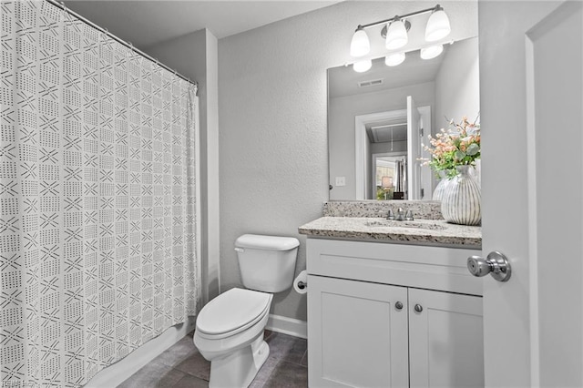 bathroom with vanity, curtained shower, toilet, and tile patterned floors