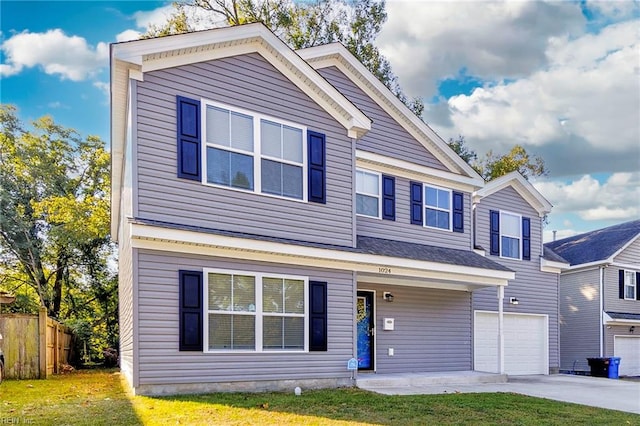 view of front of property featuring a garage and a front lawn