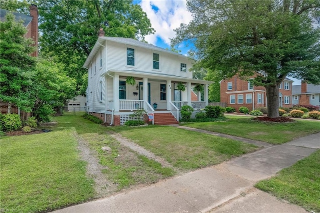 view of front of property featuring covered porch and a front yard