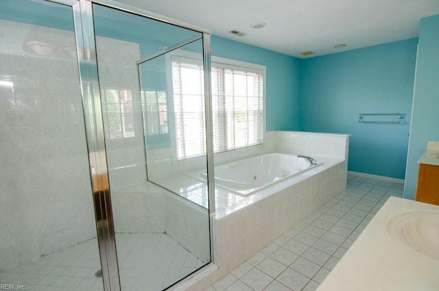 bathroom featuring vanity, independent shower and bath, and tile patterned flooring